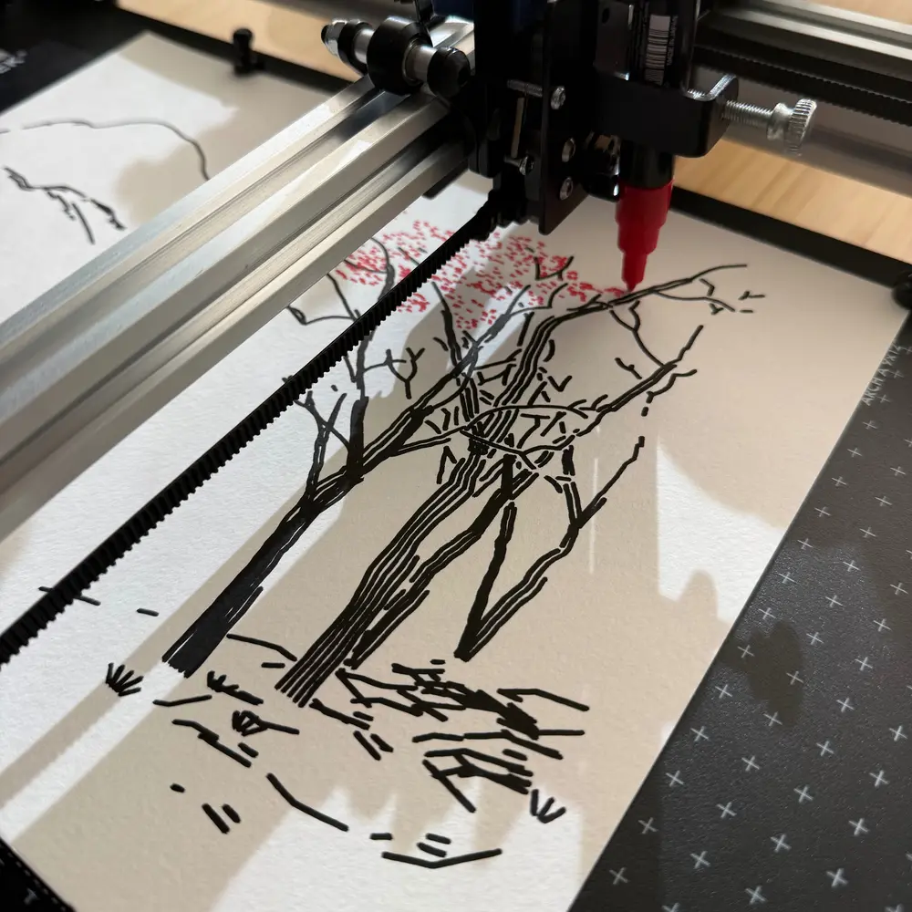 Pen plotter carriage holding a red paint marker over a drawing of black tree trunks, laying red dots into the canopy
