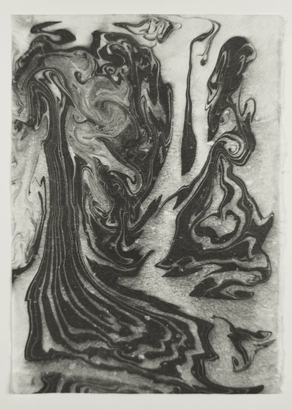 Suminagashi monoprint with fine concentric lines dissolving at edges