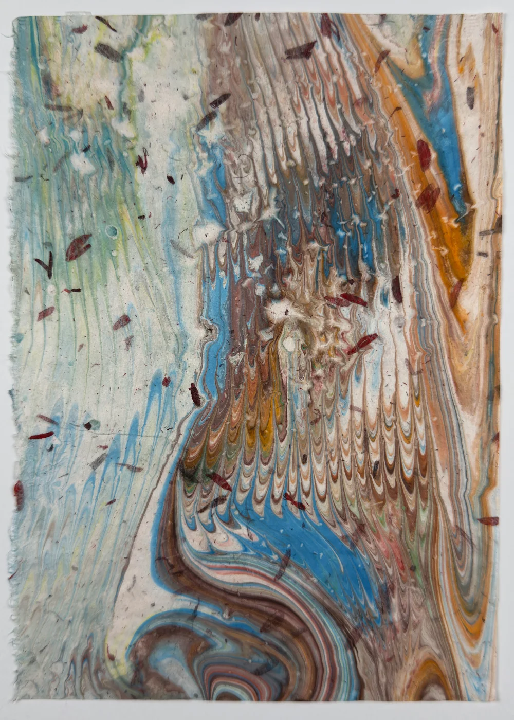 Colorful paper marbling monoprint with swirling patterns on washi paper