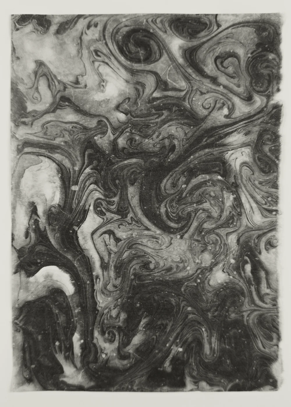 Black and white suminagashi monotype with dense overlapping rings