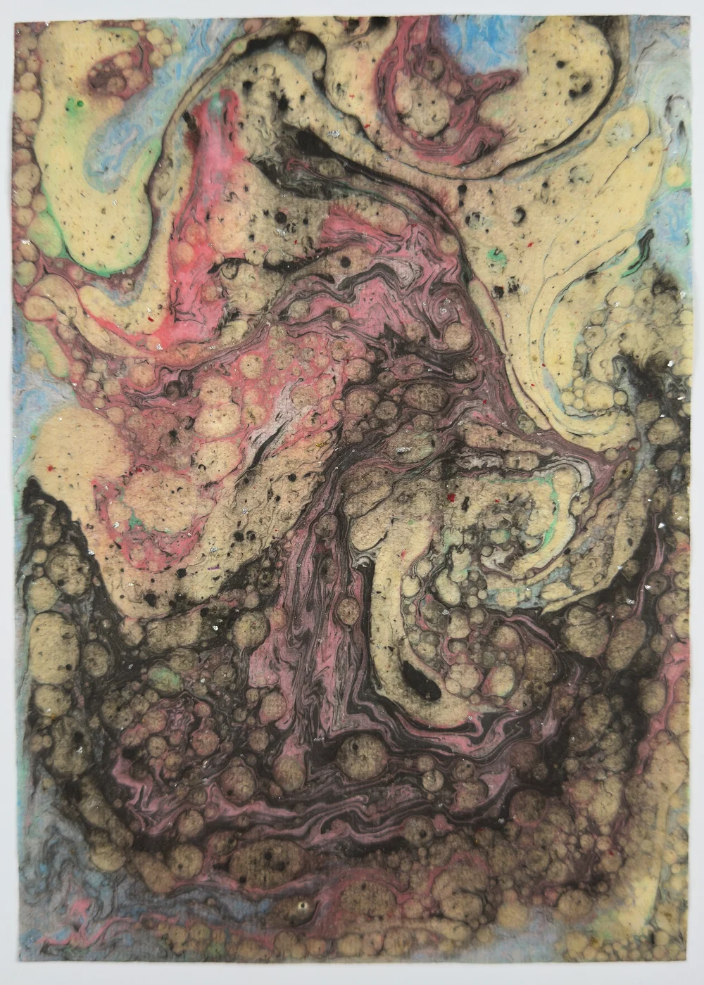 Colorful paper marbling monotype with combed wave patterns on washi paper