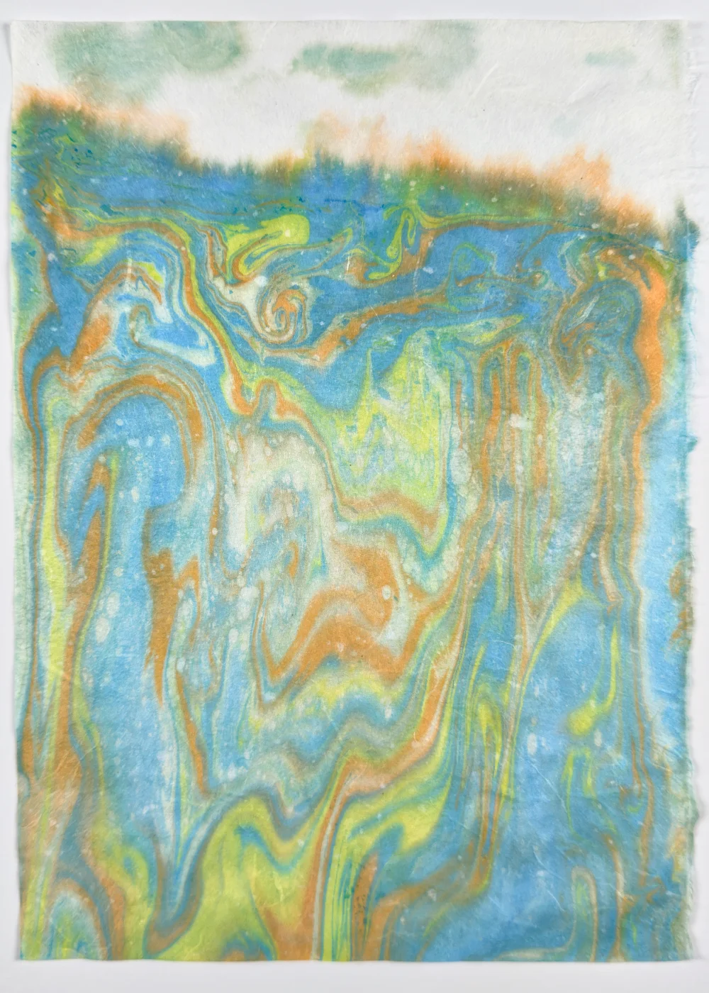 Paper marbling monotype with raked color patterns on textured washi