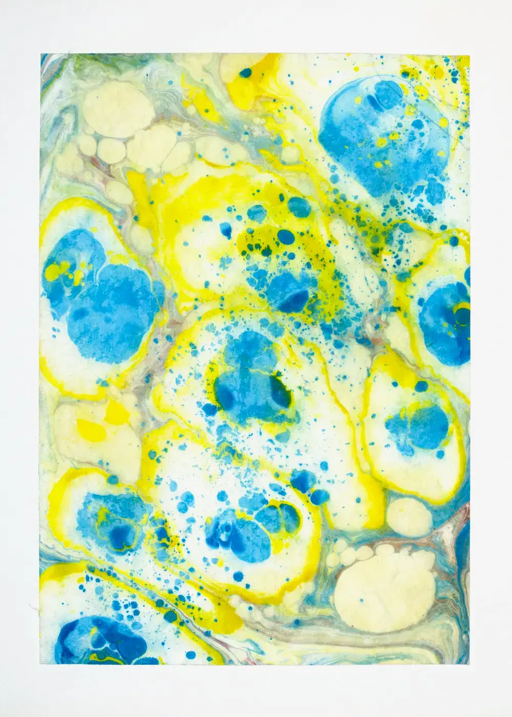 Vibrant blue pools and yellow splatter scattered across cream, with pale pooled forms at the corners