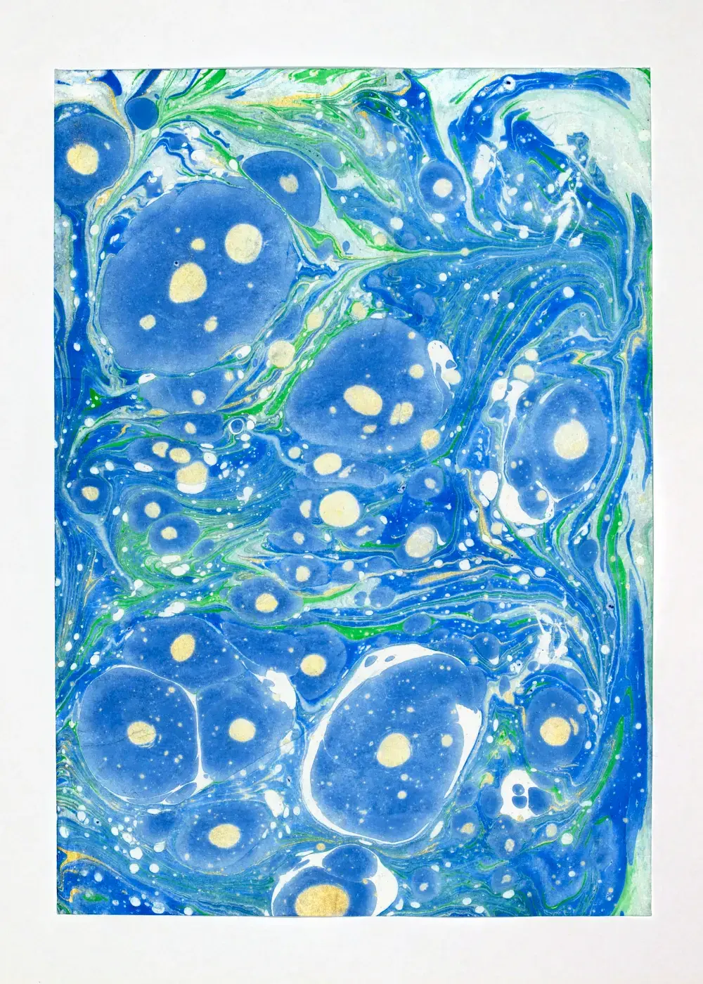 Large blue pools speckled with white and a few gold droplets, thin green veins connecting them across pale ground