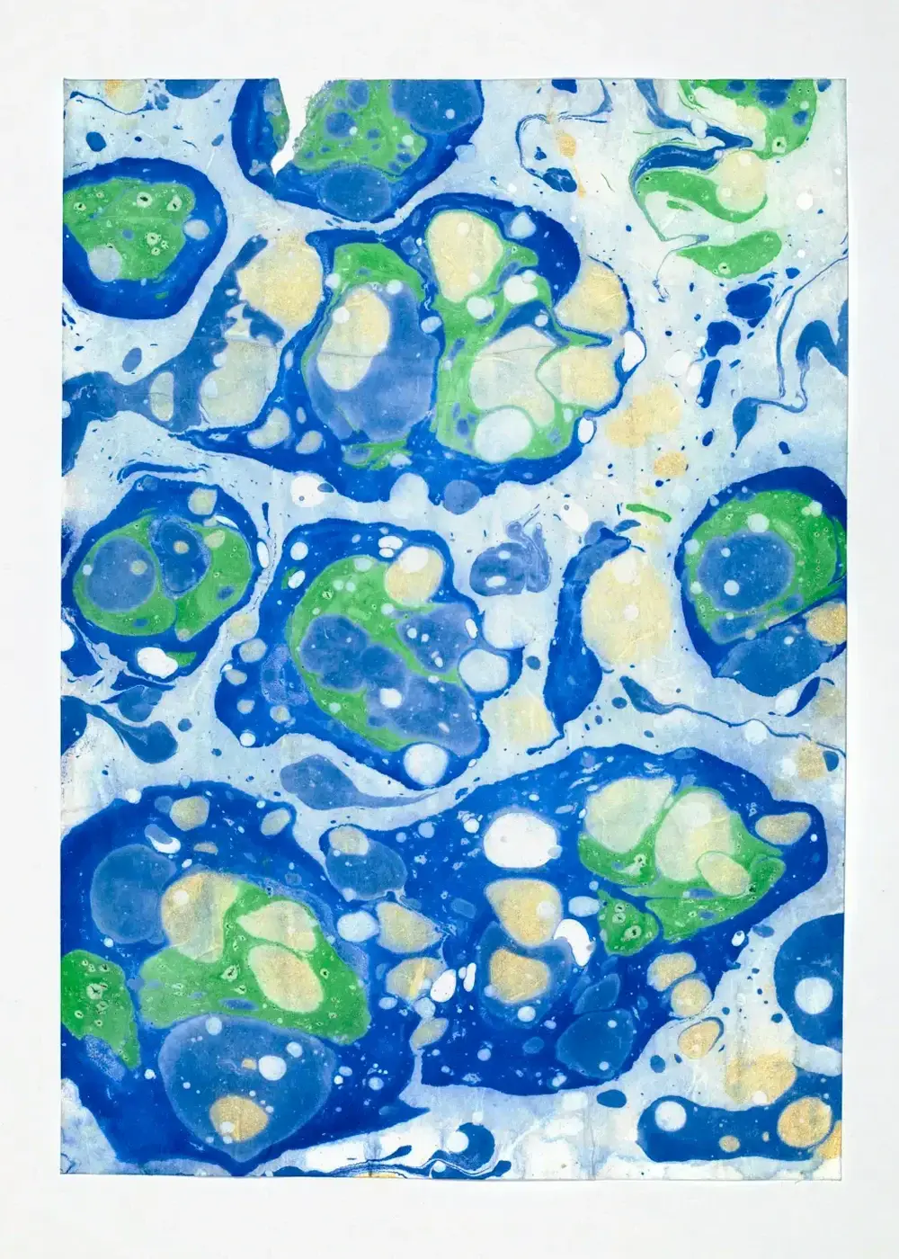 Scattered blue and green cells with cream and gold droplet cores, floating on pale washi with open negative space