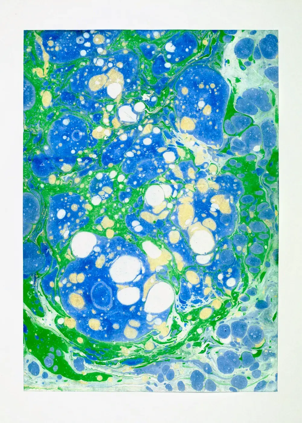 Central cluster of blue, white, and pale gold droplets ringed in emerald, scalloped border of smaller blue pools along the bottom