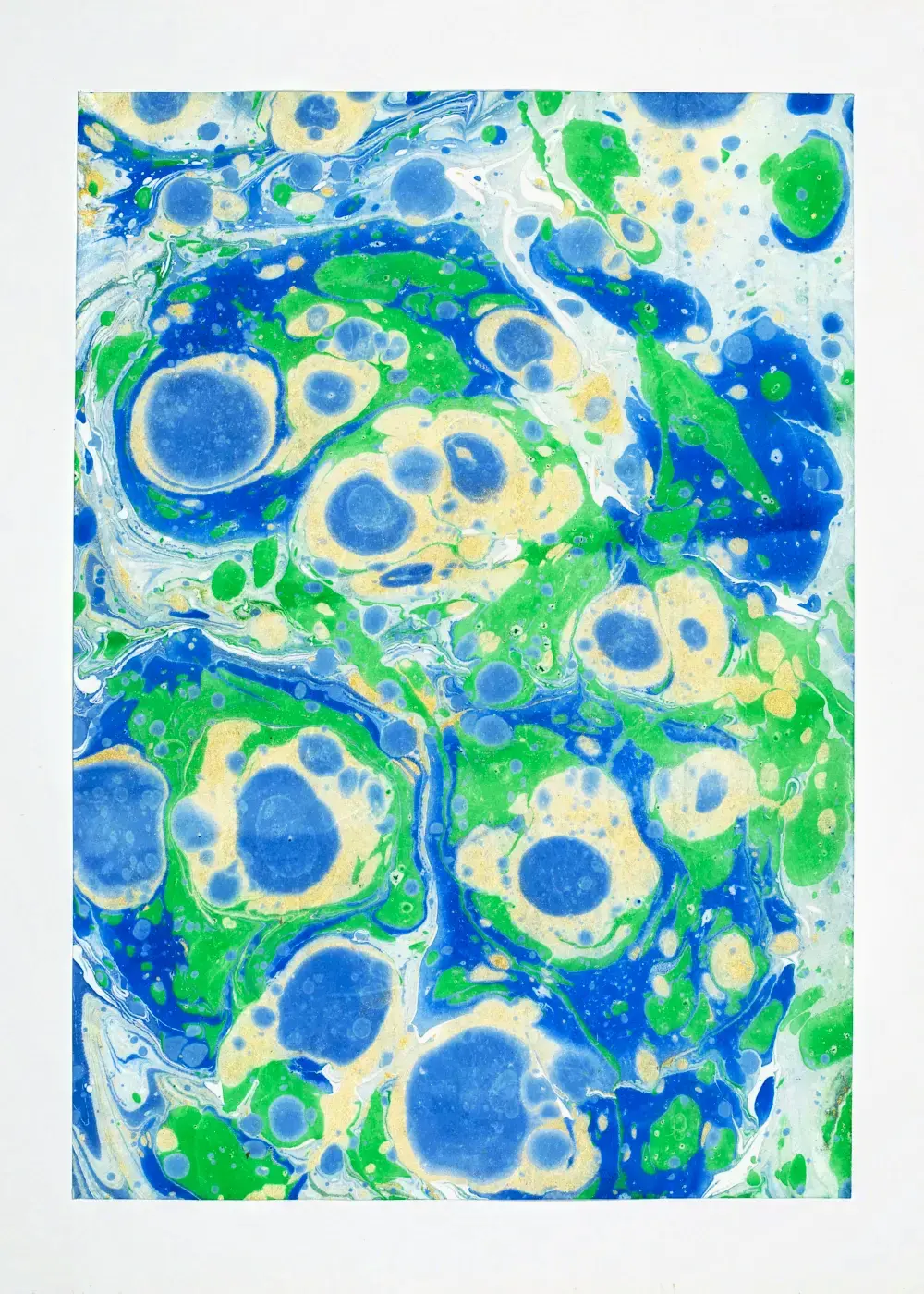 Tightly packed blue and green cells edge to edge, each ringed in green and studded with gold, like a cross-section of clustered eggs